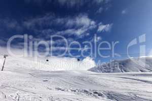 Gondola lift and ski slope at sun day