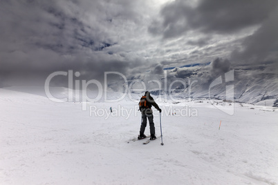 Skiers on ski slope before storm