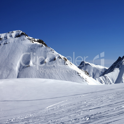 Ski slope at nice sunny winter day