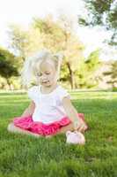 Little Girl Having Fun with Her Piggy Bank Outside