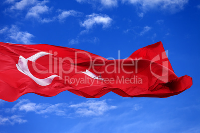 Waving flag of Turkey against blue sky