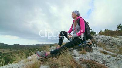 JIB CRANE: Young woman hiker on mountain top enjoying view of plateau Ai-Petri