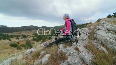 JIB CRANE: Woman hiker with backpack relaxing on top of mountain plateau Ai-Petri