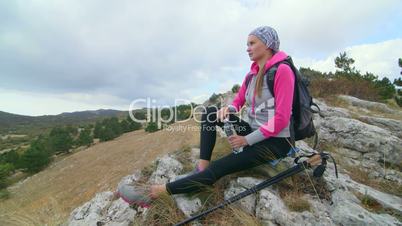 JIB CRANE: Fit young woman day hiker on top of mountain yayla looking at plateau