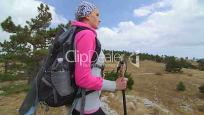 JIB CRANE: Woman day hiking walking off trail on majestic mountain plateau