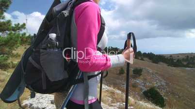 Young woman hiker hiking highland enjoying view of amazing mountain plateau