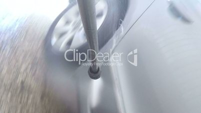 High pressure washer is used to clean car camera mounted on the spray gun nozzle