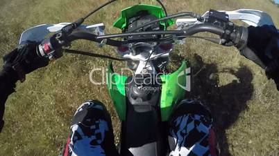 PoV: Enduro racer in motorcycle protective gear riding dirt bike off-road