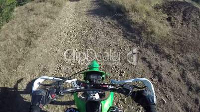 PoV: Enduro racer riding bike on dirt track through the forest