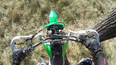 PoV: Enduro racer starting engine of dirt bike riding motorcycle on dirt track