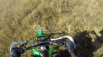 Point of View: Enduro racer on dirt bike riding off-road