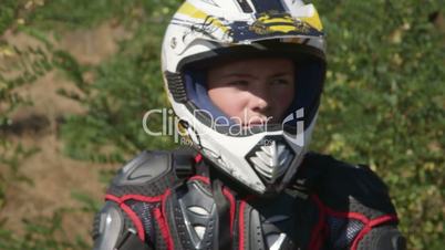 Face of young enduro racer in motorcycle protective gear closeup