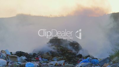 Toxic smoke from burning dump rises into the air