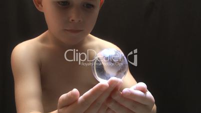 Young boy with a globe on his open