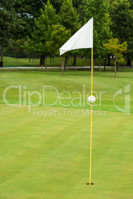 White flag on a golf course, focus on the flag