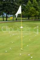 White flag on a golf course, focus on the flag