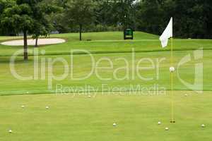 White flag on a golf course, focus on the flag