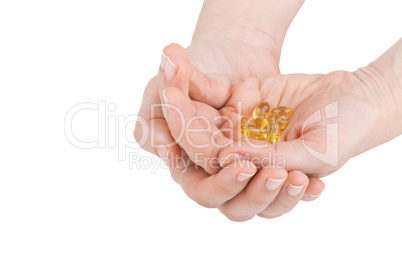Woman's hands holding vitamin D pills