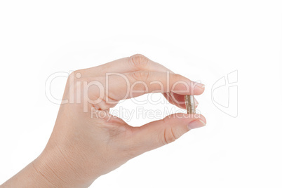 Woman's hand holding a herbal pill