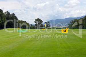 Practicing range at a golf course, with table marking 50 meters