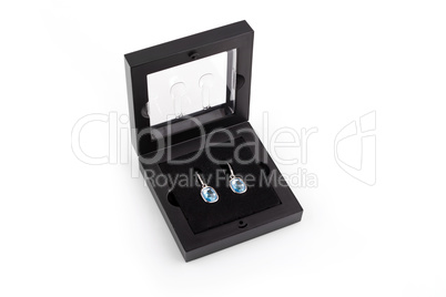 Pair of sapphire earrings in a gift box isolated on white backgr