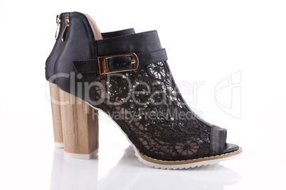 Female shoes with black lace, white sole and a wooden heel, isol