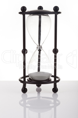 Hourglass on white background with reflection