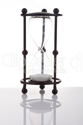 Hourglass on white background with reflection