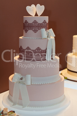 Wedding cake decorated with bows and lace