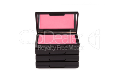 Pink blush on a pile of blush boxes isolated on white