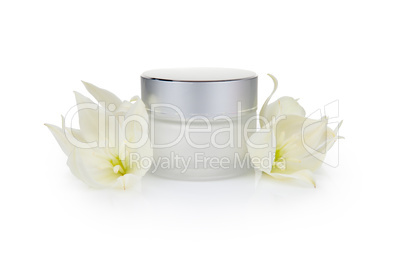 Jar with the cosmetic cream and flowers