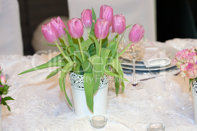 Table decorated with candles and tulips