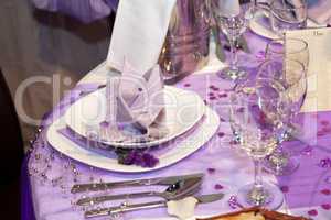 Detail of a wedding dinner setting in purple theme