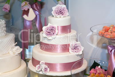 Wedding cake with roses at luxury reception