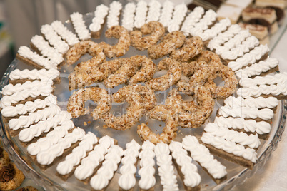 Meringue snacks and nut cookies on a plate