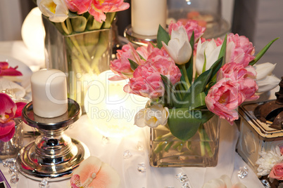 Table decorated with candle and tulips