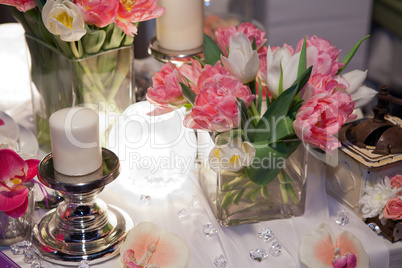 Table decorated with candle and tulips
