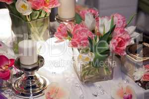 Table decorated with candle and tulips