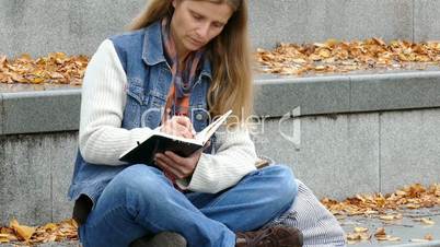 a woman writing in a book