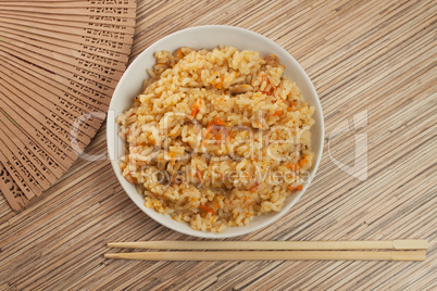bowl of tasty cooked rice with chopsticks