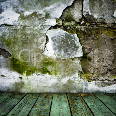 grunge painted cracked wall and wooden floor in a room