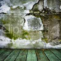 grunge painted cracked wall and wooden floor in a room
