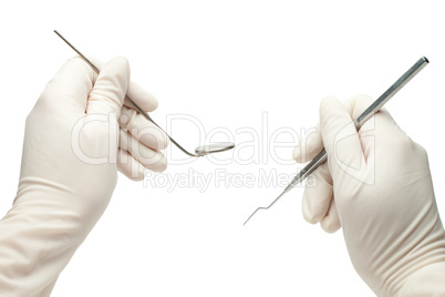 hands of dentist holding his tools during patient examination is