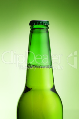 beer bottle over green background