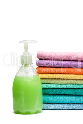 colorful towels and liquid soap isolated over white background