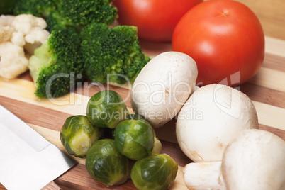 fresh food ingredients and knife on the breadboard