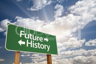 Future and History Green Road Sign Over Clouds