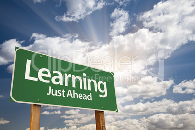 Learning Green Road Sign Over Clouds