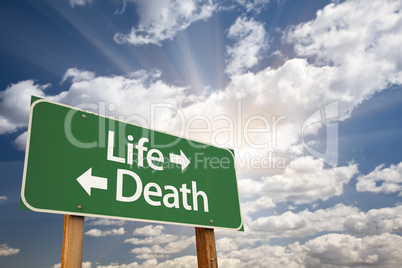 Life and Death Green Road Sign Over Clouds