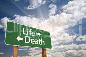 Life and Death Green Road Sign Over Clouds